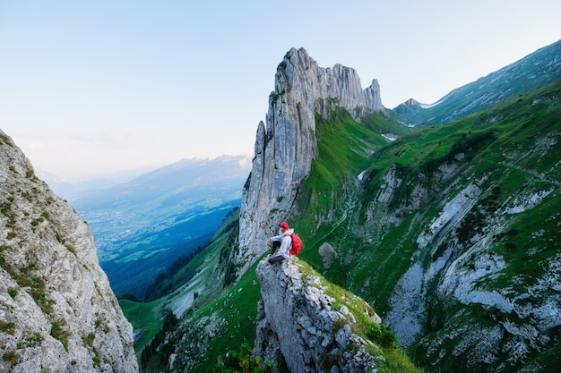 Tourist on the high rocks background Sport and active life concept Adventure and travel in the mountain region in the Switzerland mountains