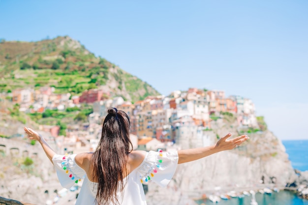 Tourist looking at scenic view of Manarola, Cinque Terre, Liguria, Italy