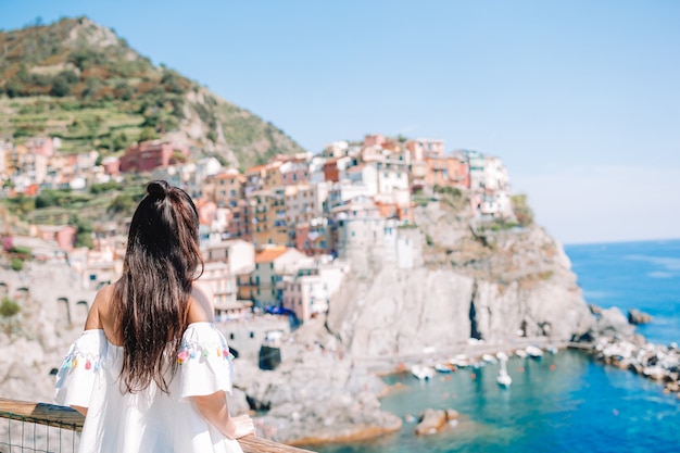 Tourist looking at scenic view of Manarola, Cinque Terre, Liguria, Italy