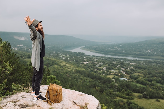 Tourist looks at beautiful summer landscape.