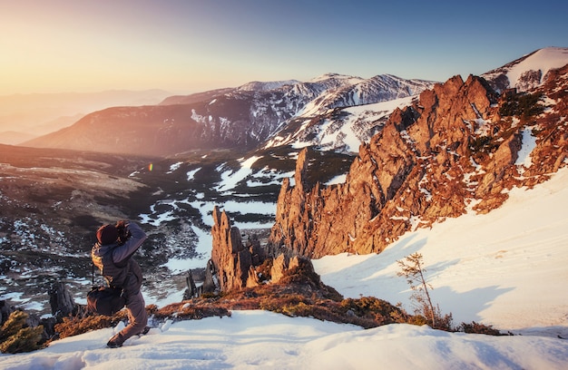 Tourist looks at the landscape. Beautiful sunset