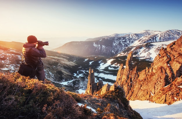 Tourist looks at the landscape. Beautiful sunset