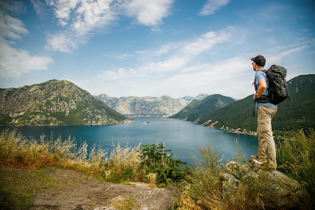 Tourist man enjoying amazing sea view of the Bay of Kotor Montenegro