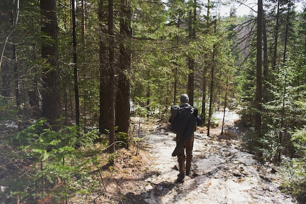 Tourist man walking on the mountainside