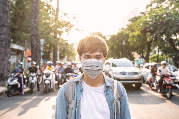 Tourist man with mask having a coffee while walking on street travel concept in the new normal