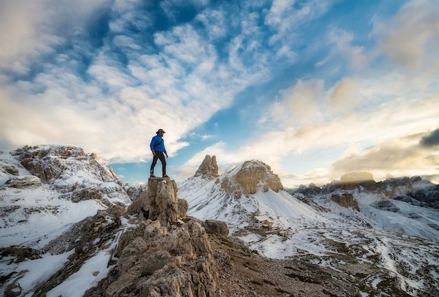 Tourist on peak of high rocks on Dolomite Alps Italy Sport and active life concept Sillhouette of winner Travel image