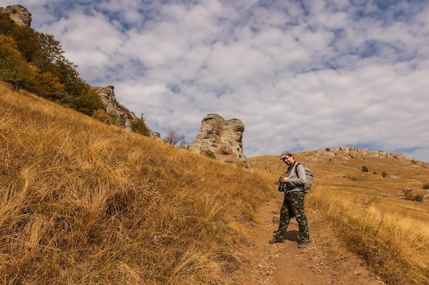 Tourist photographer on the trail of the Demerdzhi rock massif