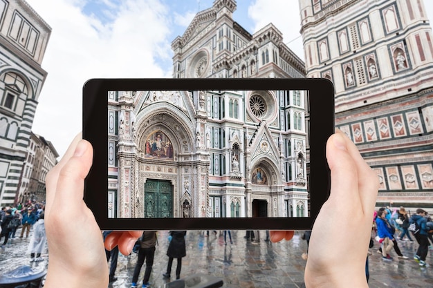 Tourist photographs facade of Duomo in Florence