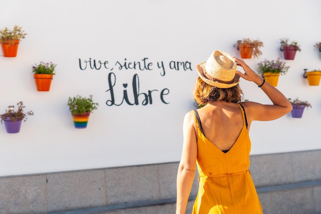 A tourist in pots with flowers with rainbow colors with lgbt colors Mijas Malaga