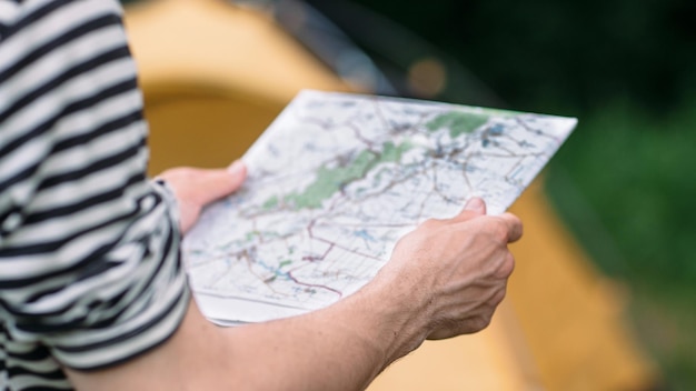 Tourist reading geographic map