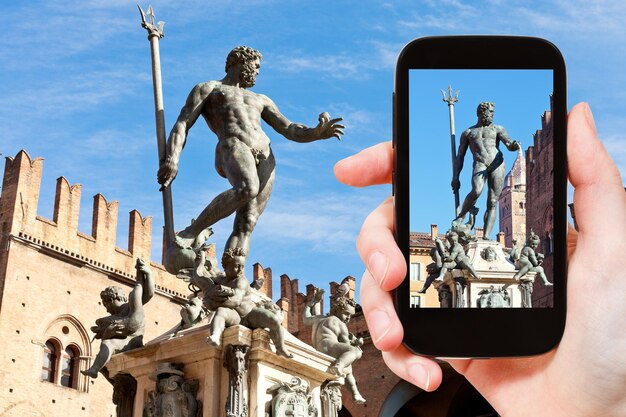 Tourist snapping photo of fountain of neptune