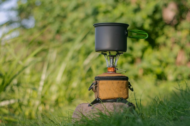 Tourist stove gas for camping and recreation on the background of nature