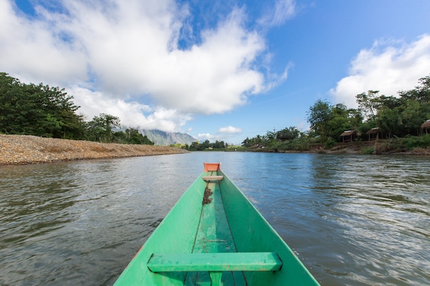 tourist take a boat in song river at Vang Vieng