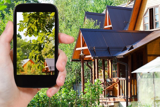 Tourist takes picture of yard of village house