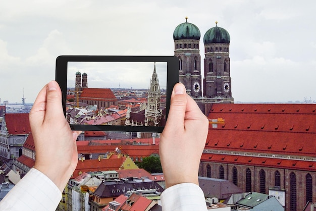 Tourist taking photo of Frauenkirche in Munich