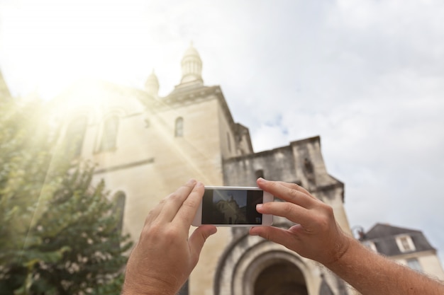 Tourist taking photo of french village