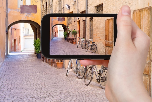 Tourist taking photo of italian medieval street