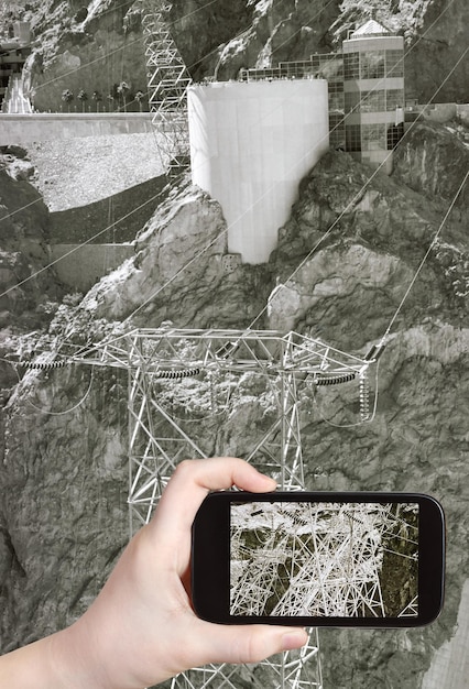 Tourist taking photo of power line of Hoover Dam