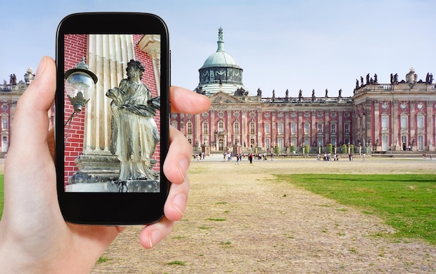 Tourist taking photo of statue in Sanssouci