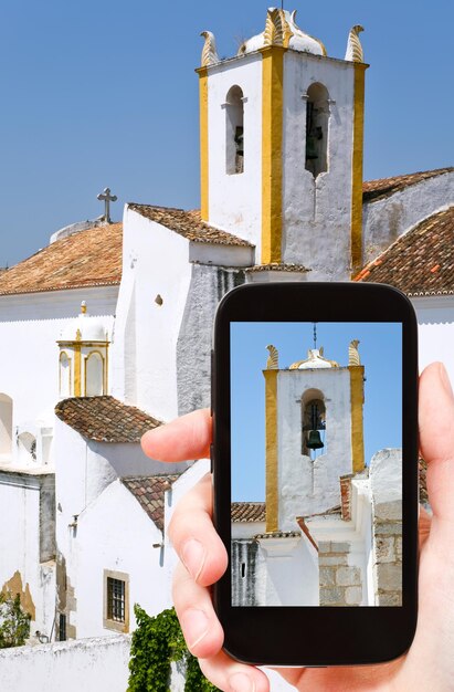 Tourist taking photo of white houses in Algarve