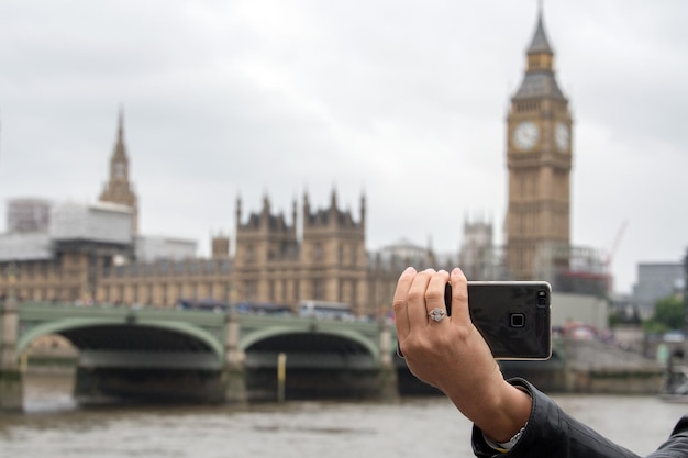 Tourist taking pictures at London Bridge