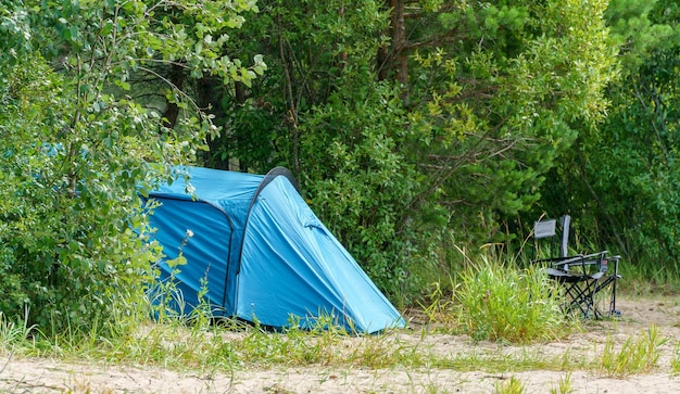 Tourist tent on the lake Journey to the wild places of nature