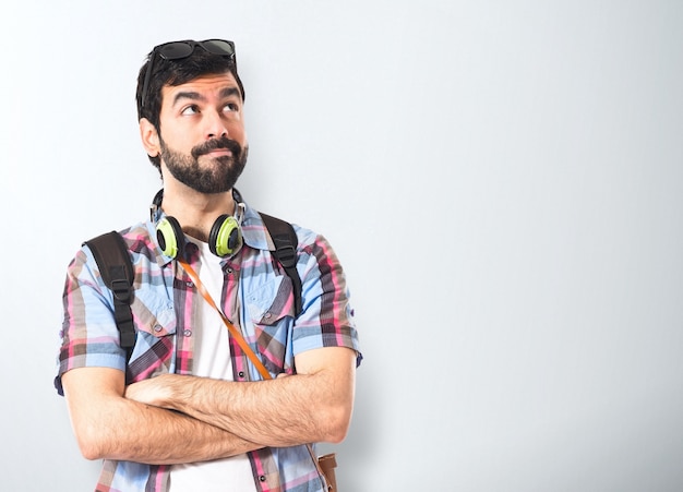 Tourist thinking over white background