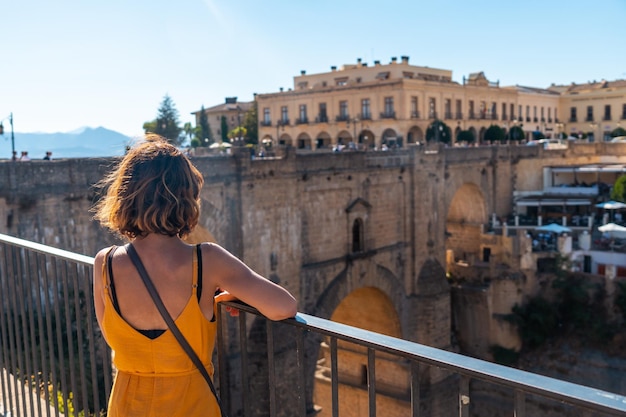 A tourist at the viewpoint visiting the new bridge in Ronda province of Malaga Andalucia