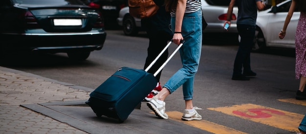 Tourist walking with luggage in the city