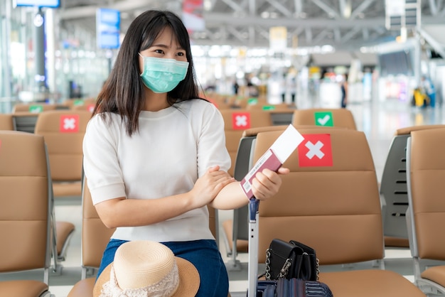 Tourist wearing mask looking happy while smiling behind the mask