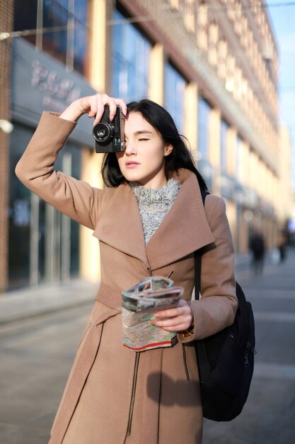 Tourist with camera and map