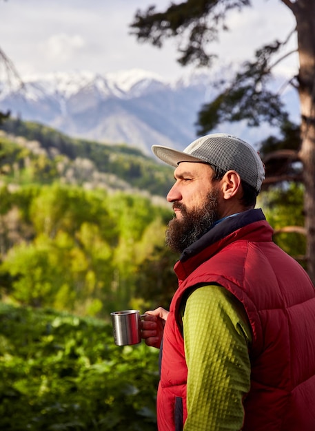 Tourist with coffee in the woods