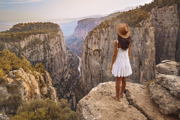 Tourist woman on the edge of a cliff of tazi canyon in manavgat antalya turkey greyhound canyon