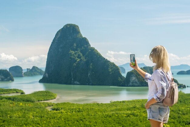 Tourist woman enjoying view of beautiful hills and sea travelin in Thailand Southeast Asia