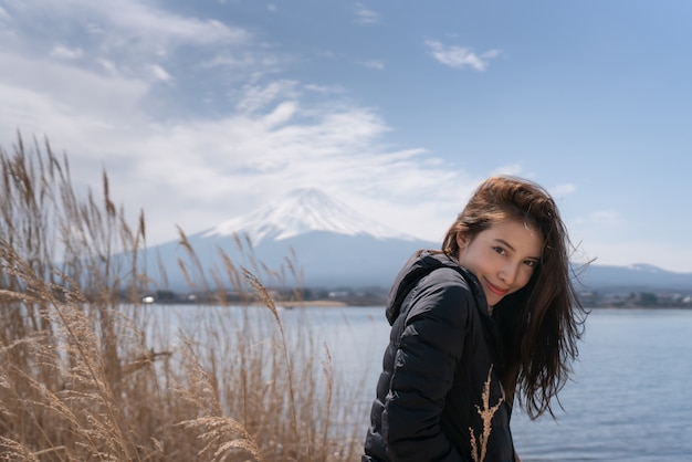 Tourist woman at Kawaguchiko lake in Japan.