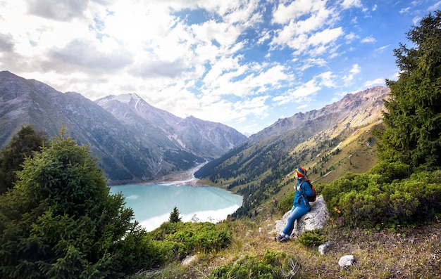 Tourist woman with backpack at the mountains