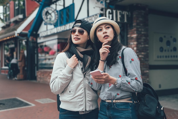 Tourist women try navigate with online map