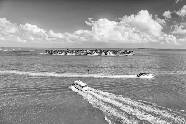 Touristic yachts floating by green island at Key West Florida