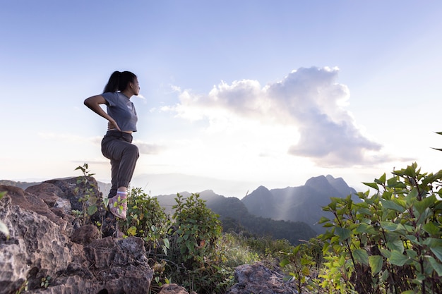 Tourists are standing on top of the mountain.