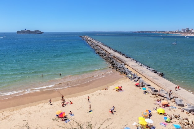 Tourists are sunning on the beach at the entrance to the Marina,.