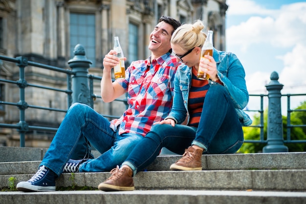 tourists enjoying the view from bridge at the Museum Island in Berlin with beer