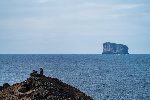 Tourists over the hill looking at the islet