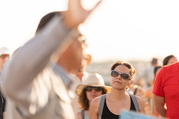 Tourists listening to the explanations of a guide