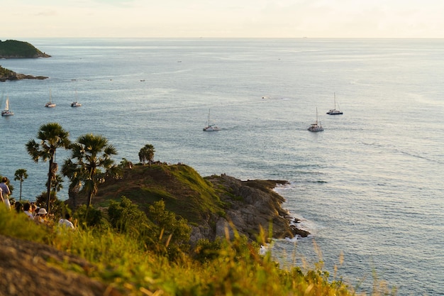 Tourists at Phromthep cape viewpoint at the south of Phuket Island, Thailand. Tropical paradise in Thailand. Phuket is a popular destination famous for tourists