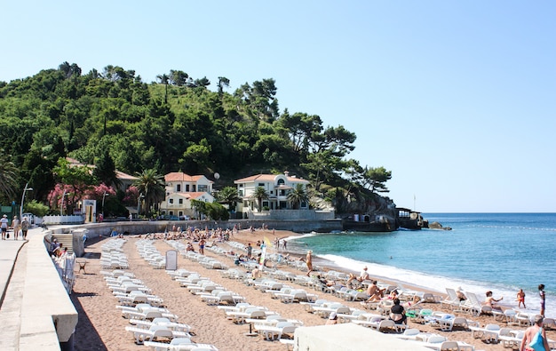 Tourists relax on the beach in PETROVAC, MONTENEGRO