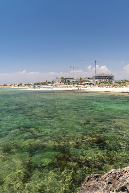 Tourists relax on the beautiful Ayia Thekla Beach