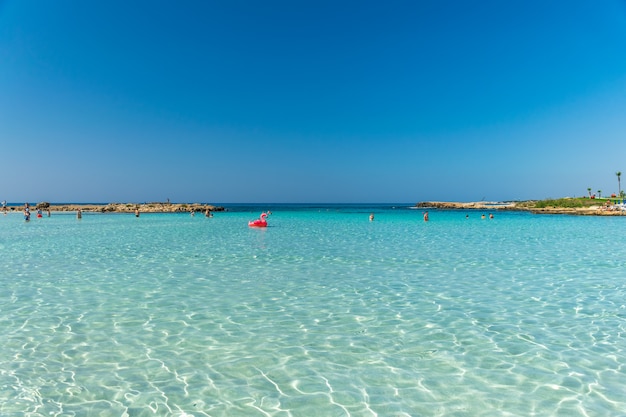 Tourists relax and swim on one of the most popular beaches on the island.