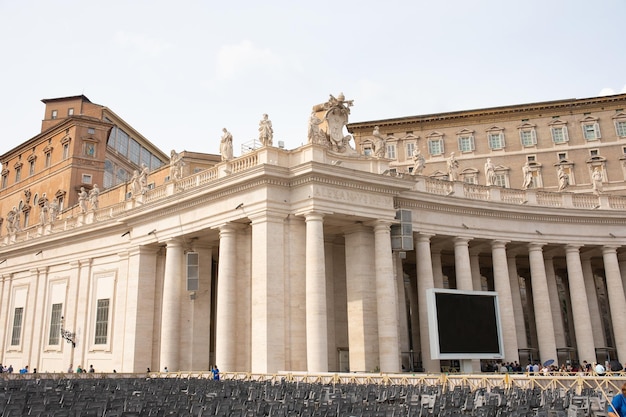 Tourists on the St. Peter's Square, architectural masterpiece with Michelangelo's dome in Vatican.