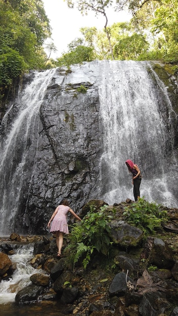 Tourists visiting waterfalls in the jungle of Peru Quillabamba