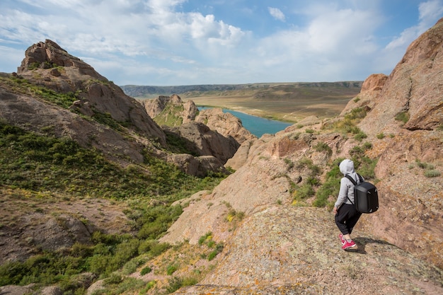 Tourists with backpacks relaxing on rocks